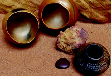 beautiful pottery pices displayed on a sandy backgroun